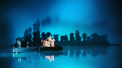 Image showing Chess With Dark Shadows On A Blue Background