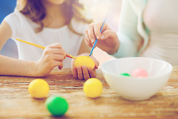 Image showing daughter and mother coloring easter eggs