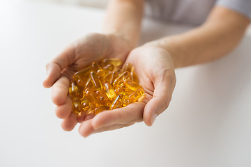 Image showing hands holding cod liver oil capsules