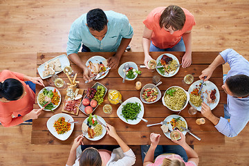 Image showing group of people eating at table with food