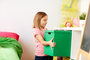 Image showing happy little girl with toy box at home