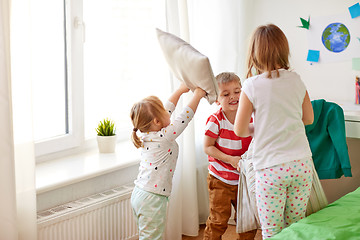 Image showing kids playing and fighting by pillows at home