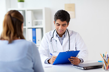 Image showing doctor with clipboard and patient at hospital