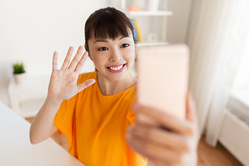 Image showing happy asian woman taking selfie by smartphone
