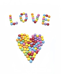 Image showing Word ''Love'' and abstract heart from bright colorful candy 