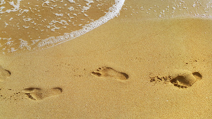 Image showing Sea water and footprints in the sand at the beach