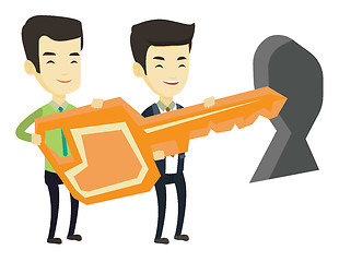 Image showing Business people holding key in front of keyhole.