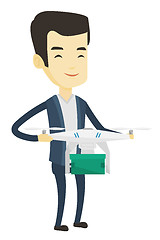 Image showing Man controlling delivery drone with post package