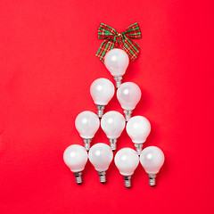 Image showing The christmas tree from lantern lamps laying on red background with copy space.