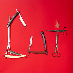 Image showing combs and hairdresser tools on red background top view