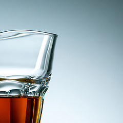 Image showing The curved glass of whiskey or alcohol drink