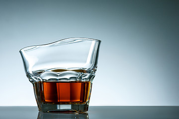 Image showing The curved glass of whiskey or alcohol drink