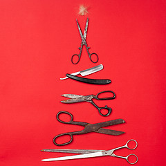 Image showing combs and hairdresser tools on red background top view