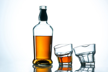 Image showing The curved glass of whiskey or alcohol drink