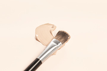 Image showing Cosmetic foundation cream and powder with brush