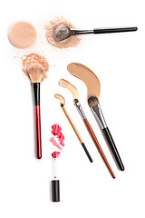 Image showing Close-up of crushed mineral shimmer powder golden color with makeup brush