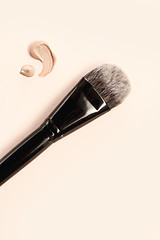 Image showing Cosmetic foundation cream and powder with brush