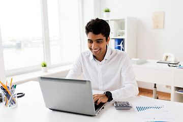 Image showing businessman with laptop and papers at office