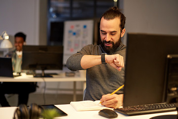 Image showing man with smartwatch using voice recorder at office