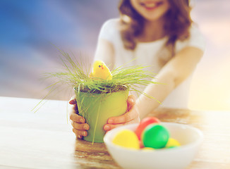 Image showing close up of girl with easter toy chicken and eggs