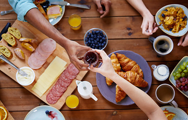 Image showing people having breakfast at table with food