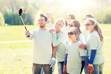 Image showing group of volunteers taking smartphone selfie