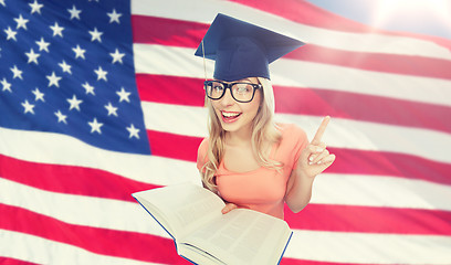 Image showing student woman in mortarboard with encyclopedia