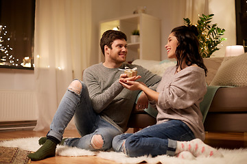 Image showing happy couple with gift box at home