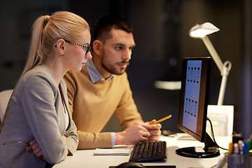 Image showing business team with computer working late at office