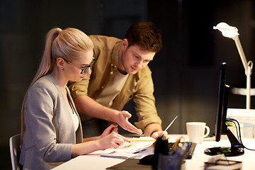 Image showing business team with papers working at night office