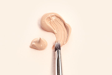 Image showing Cosmetic foundation cream and powder with brush