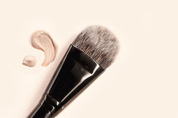 Image showing Cosmetic foundation cream and powder with brush