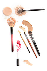 Image showing Close-up of crushed mineral shimmer powder golden color with makeup brush