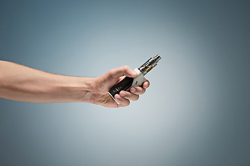 Image showing Hand holding an electronic cigarette