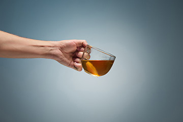 Image showing Man holding a cup of coffee