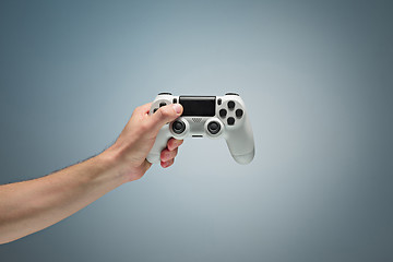 Image showing Male Hands Holding Gamepad