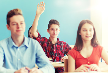 Image showing group of students with notebooks at school lesson