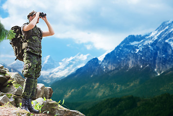 Image showing soldier with backpack looking to binocular