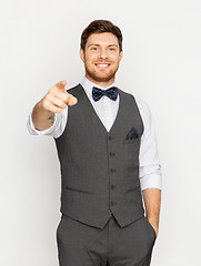 Image showing happy man in festive suit pointing finger at you