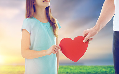 Image showing close up of daughter and father holding red heart