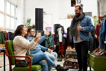 Image showing friends choosing clothes at vintage clothing store