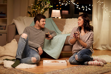 Image showing happy couple drinking coffee and eating at home