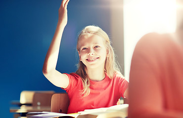 Image showing happy student girl raising hand at school lesson