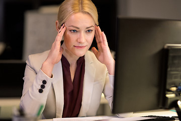 Image showing businesswoman with computer at night office