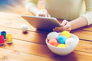 Image showing close up of woman with tablet pc and easter eggs