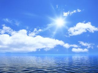 Image showing blue sky with some clouds and the sun over the ocean