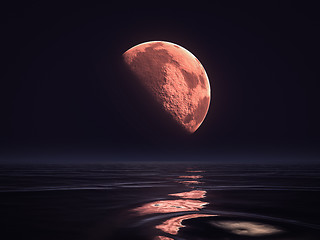 Image showing red moon rising over the ocean