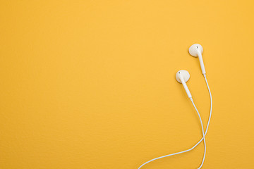 Image showing White earphones on yellow background with copy space