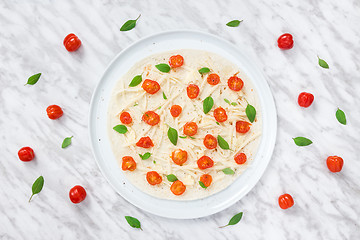 Image showing Preparing vegetarian tortilla with tomatoes, cheese and basil