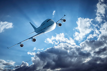 Image showing An airplane and the dramatic sky